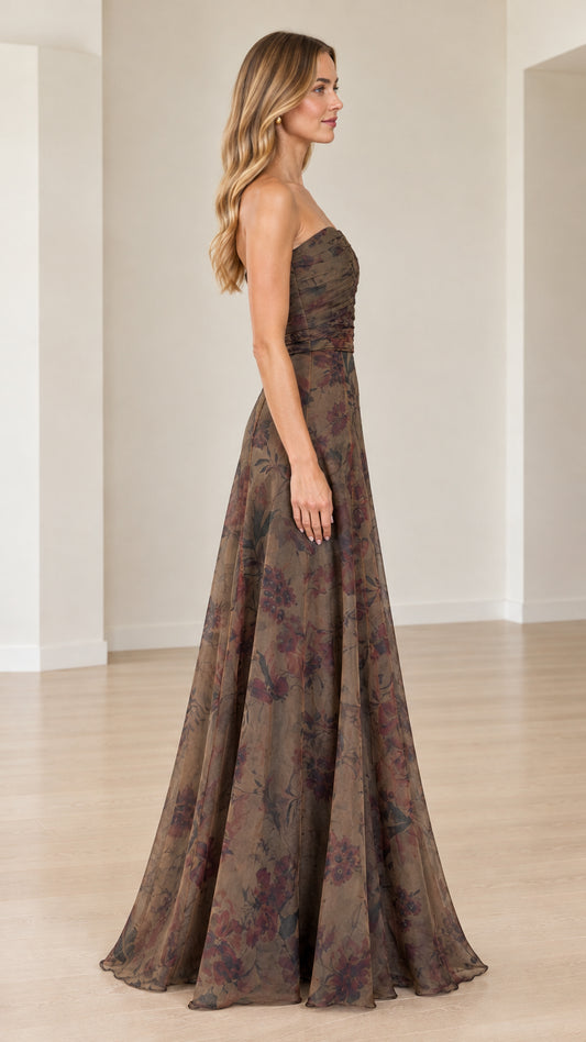 Side profile of model wearing mocha strapless floral maxi gown