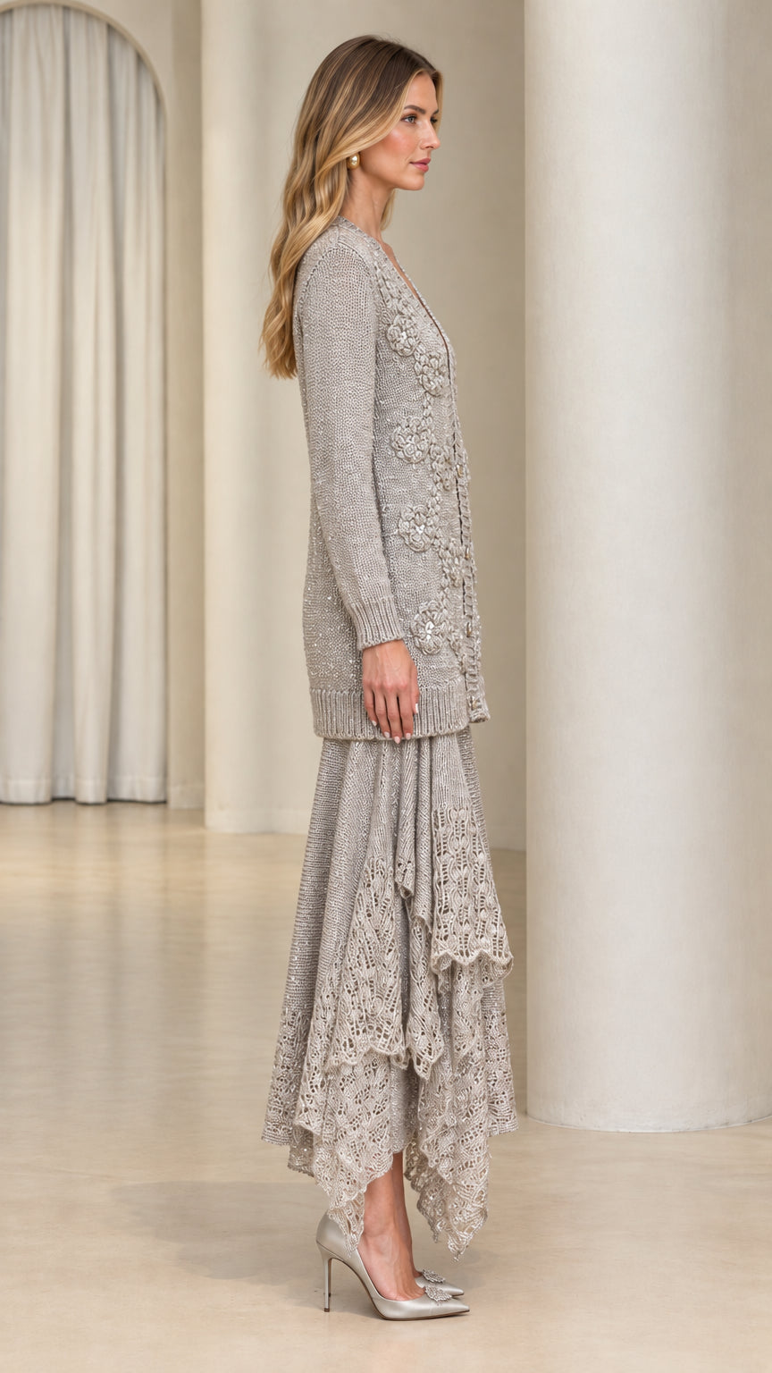Side view of model wearing silver grey knit cardigan and ruffled lace midi skirt set