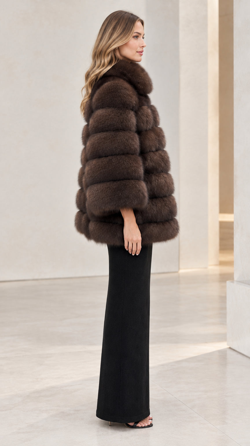 Side profile view of woman wearing chocolate brown plush faux fur cape jacket