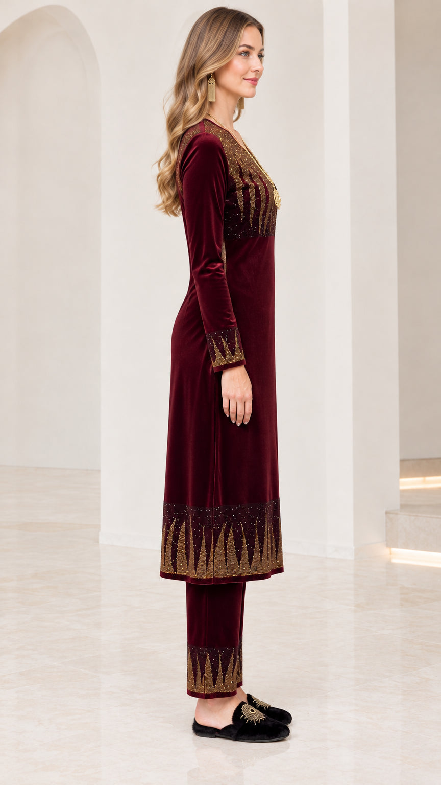 Side profile of women's burgundy velvet long tunic and trouser two-piece set