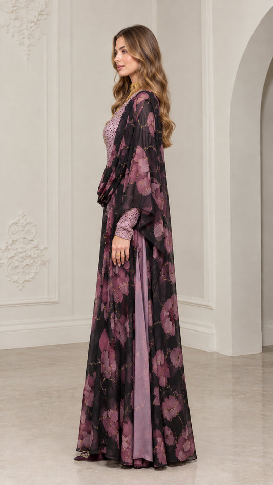 Side view of model in black floral kaftan dress with draped overlay