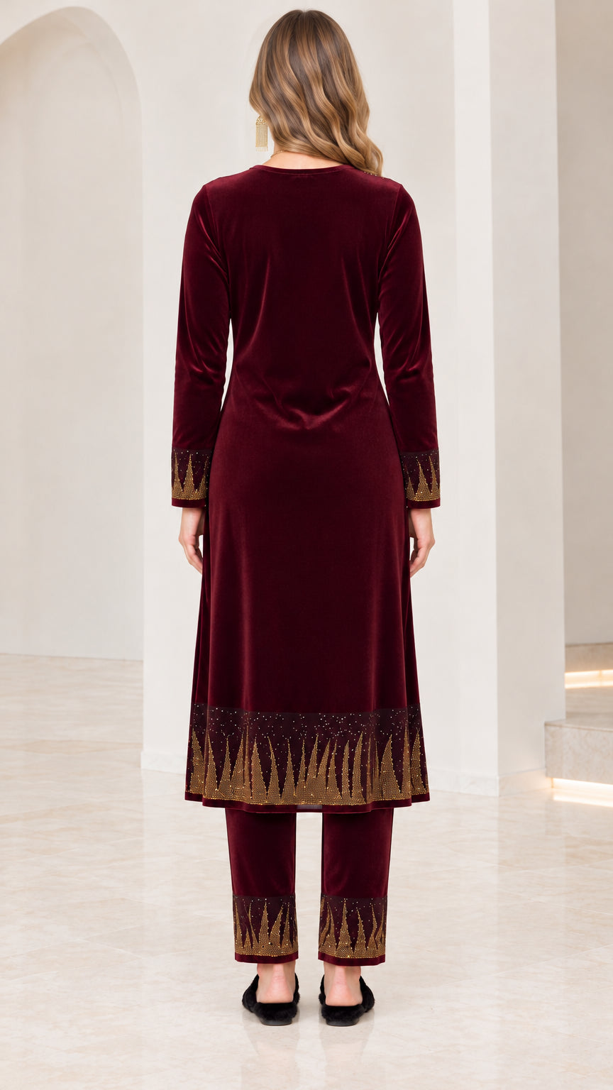 Back view of women's burgundy velvet tunic and coordinating pant set