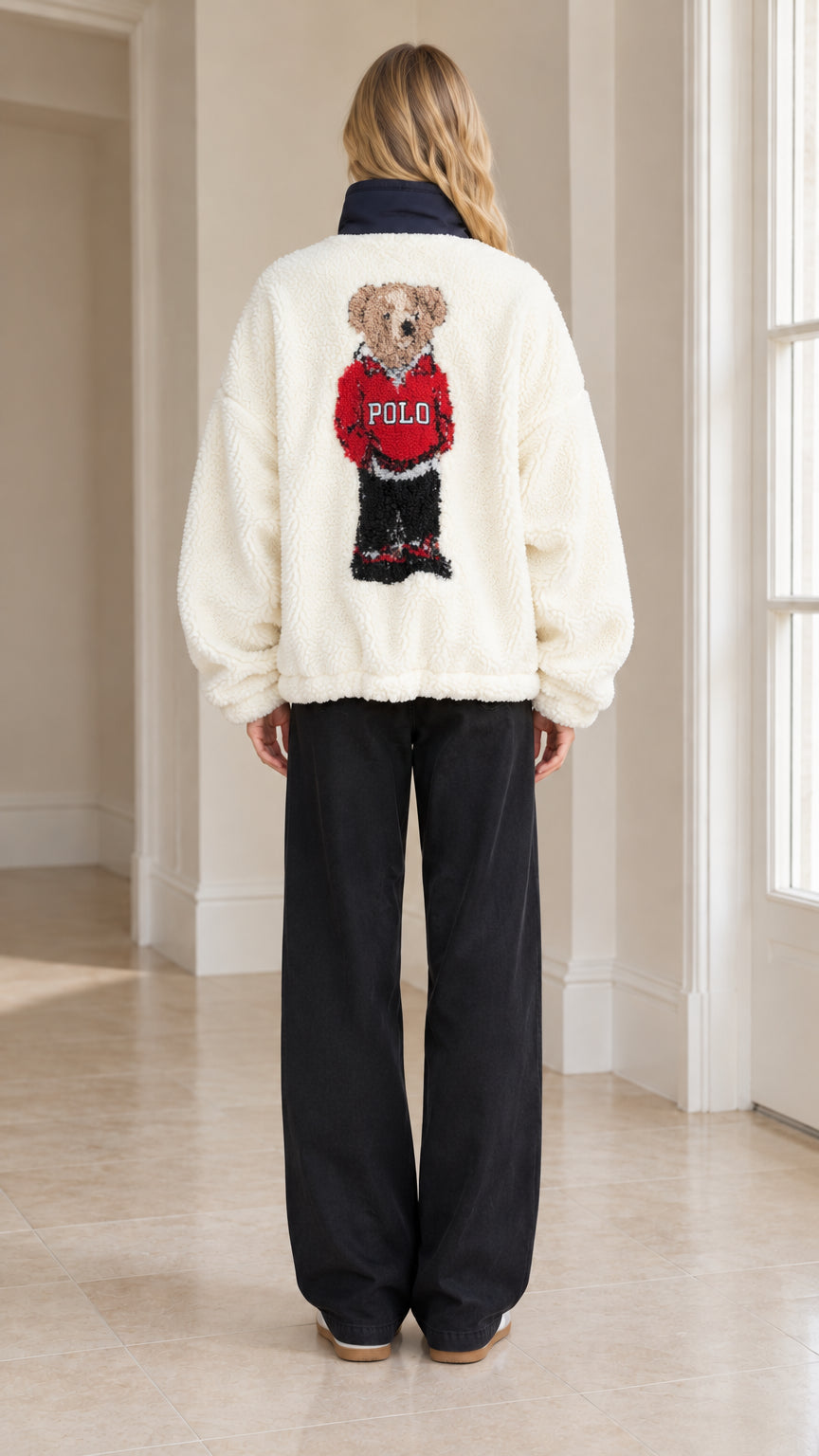 Back full-length view of woman showcasing teddy bear graphic on Cream sherpa fleece pullover
