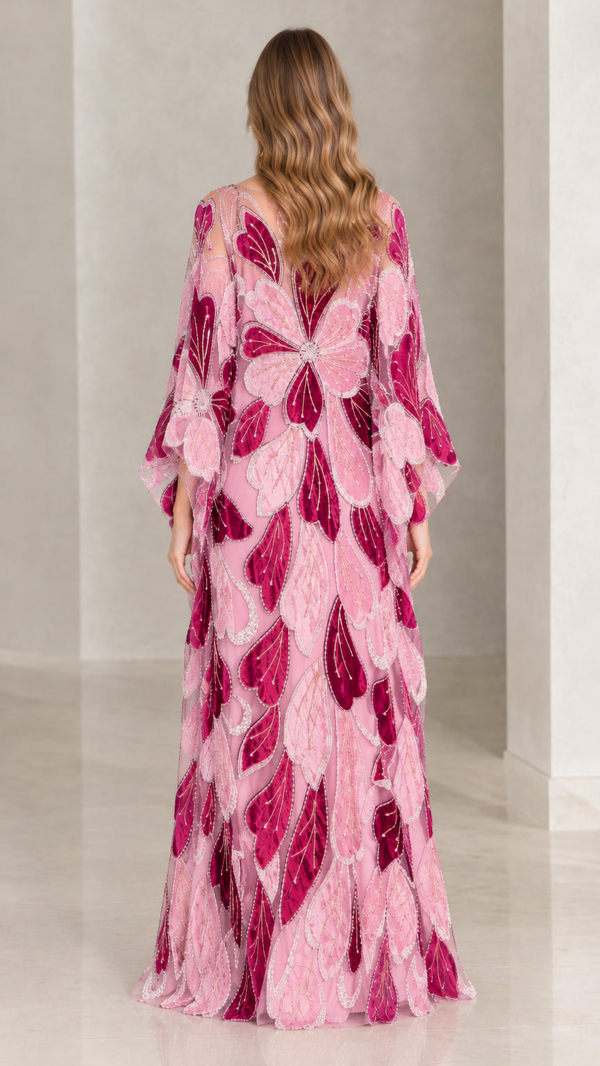 Back view of model in pink floral leaf embroidered floor-length kaftan