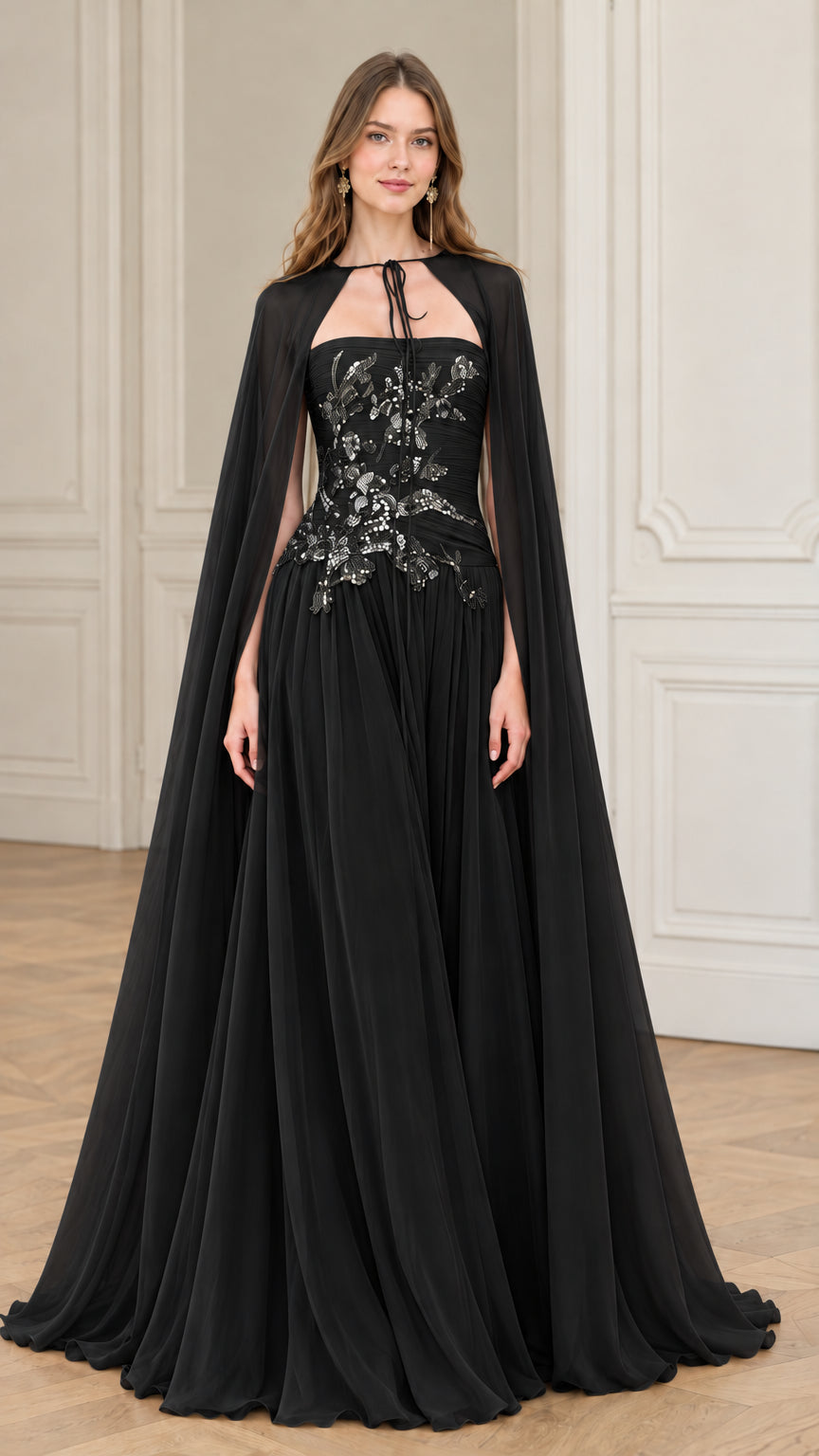 Black strapless embellished evening gown styled with matching floor-length cape