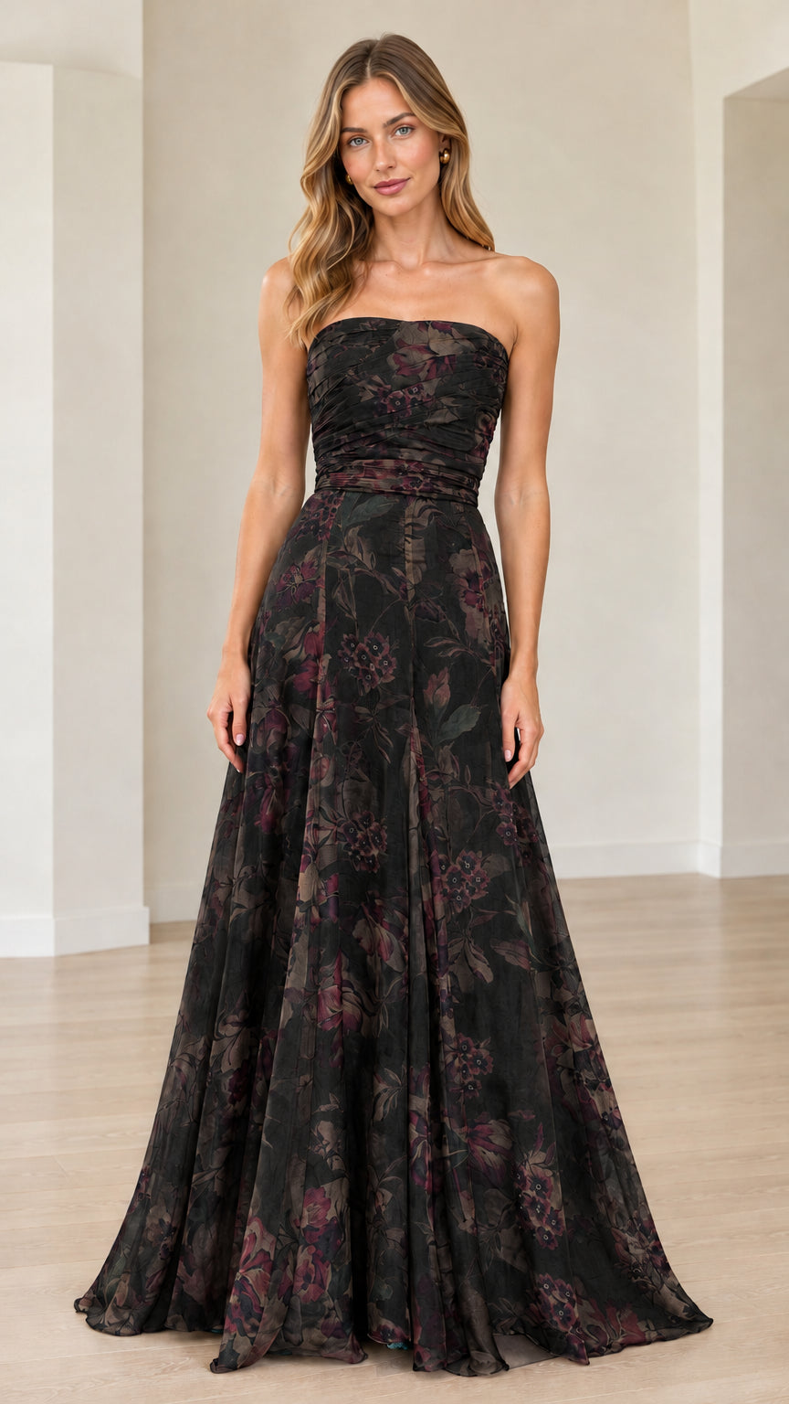 Front view of model wearing black floral strapless maxi gown