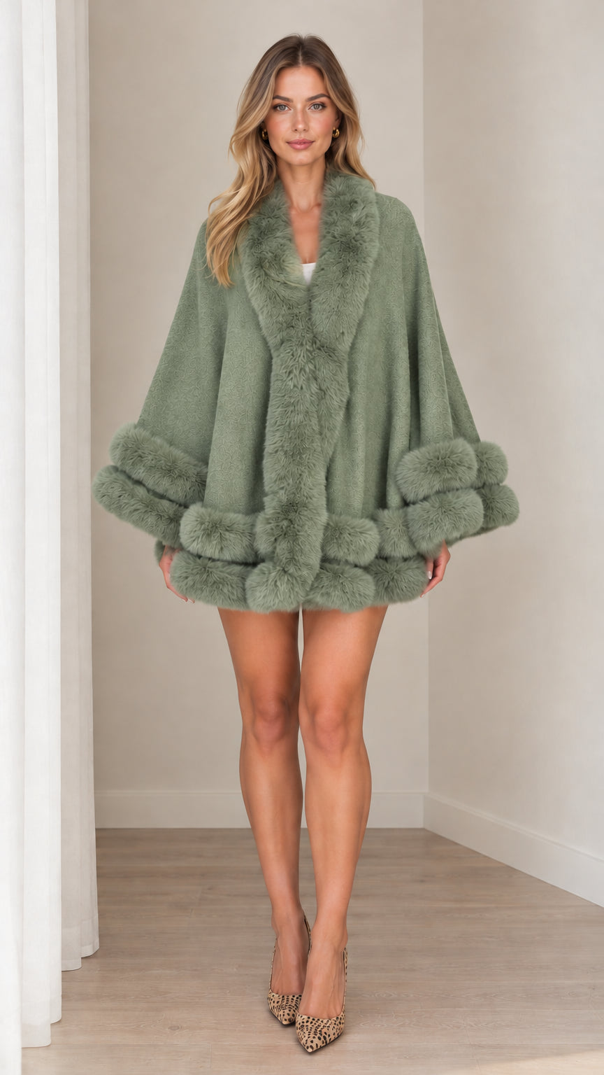 Model wearing sage green faux fur trim cape coat with leopard print heels