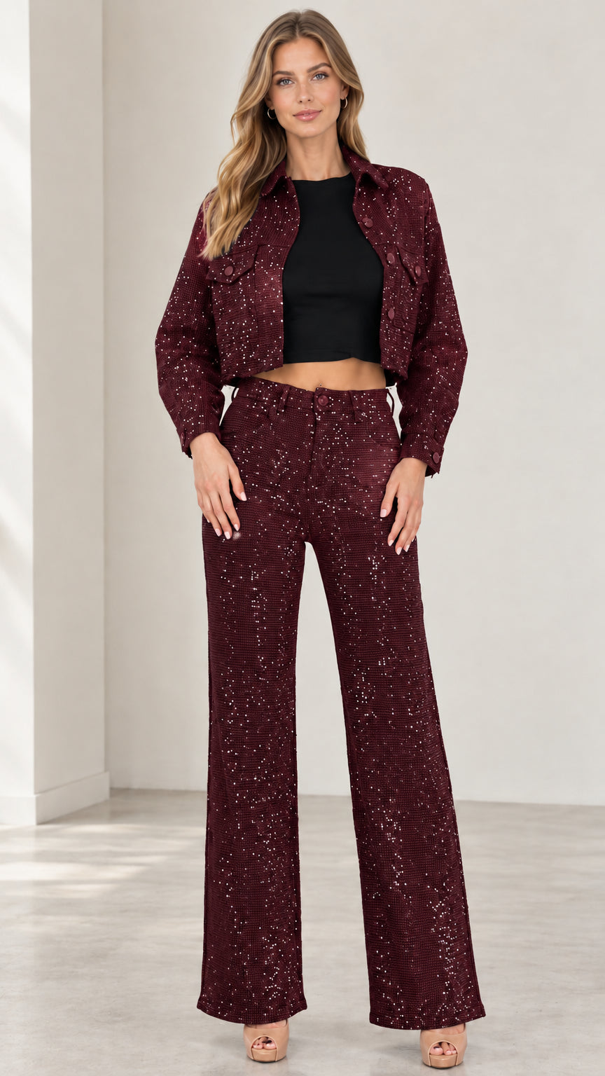Front view of woman wearing burgundy sparkle cropped jacket and matching pants set