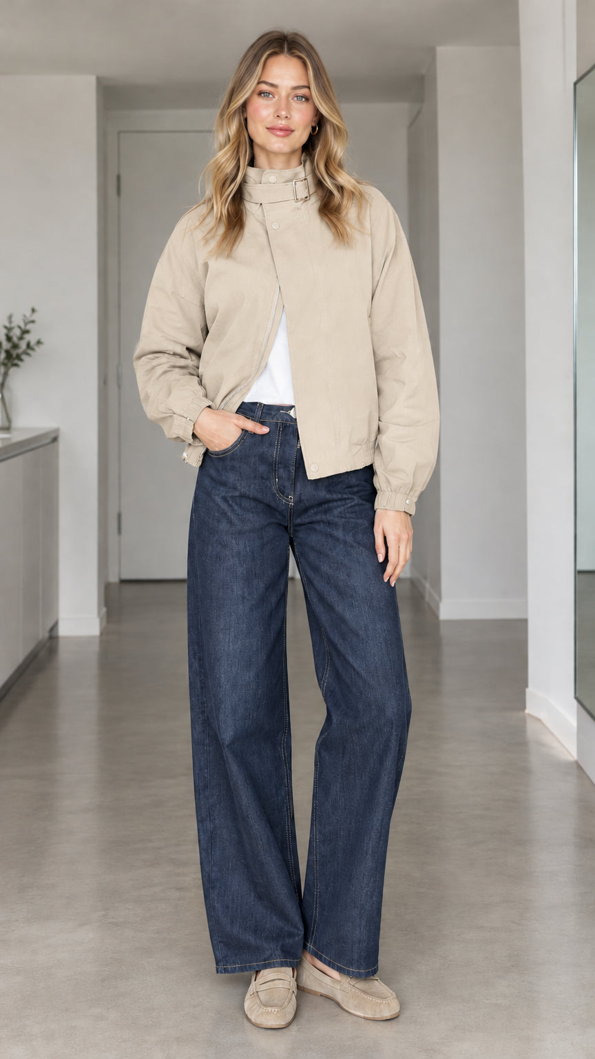 Front view of model wearing beige high-collar buckle bomber jacket