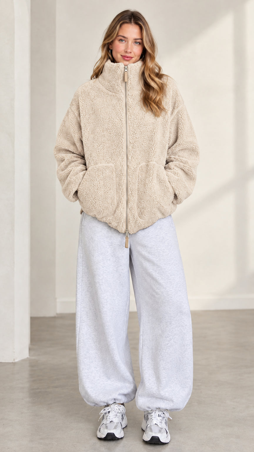 Front view of model wearing beige cream plush teddy fleece jacket