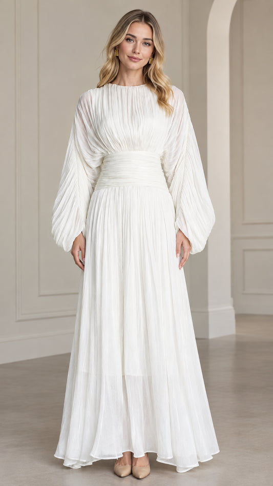 Front full-length view of woman wearing white pleated long sleeve maxi dress