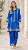 Front full-length view of woman wearing royal blue embroidered tunic and pants set