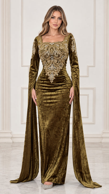 Front full view of woman wearing olive green embroidered velvet evening gown with flowing cape sleeves