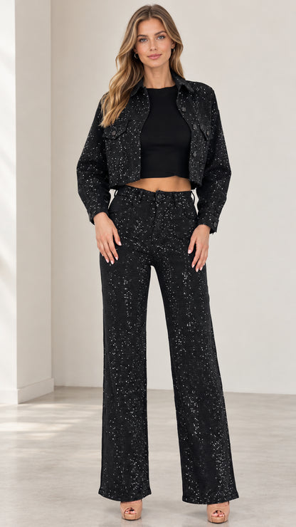 Front full-length view of woman wearing black sparkle cropped jacket and wide-leg trousers set