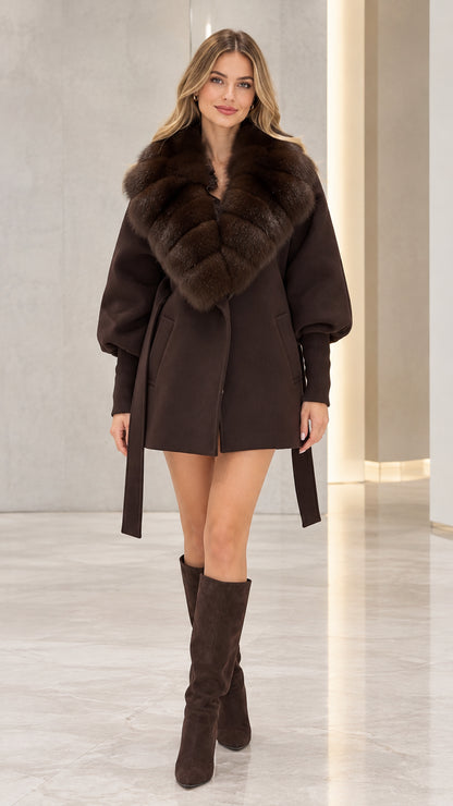 Front view of model wearing a chocolate brown belted coat with faux fur collar