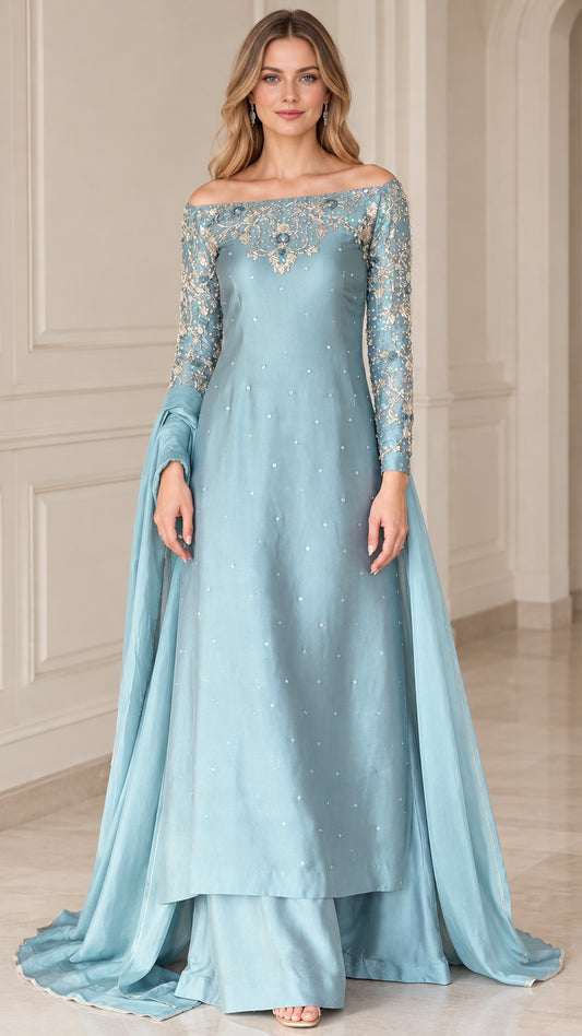 Full front view of dusty blue off-the-shoulder embroidered evening gown set with long sleeves and flowing drape
