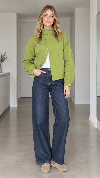 Front view of model wearing a green high-collar buckle bomber jacket paired with wide-leg jeans