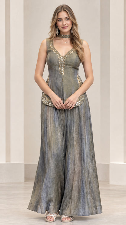Front view of woman wearing slate grey sleeveless embroidered peplum top and wide-leg palazzo pants