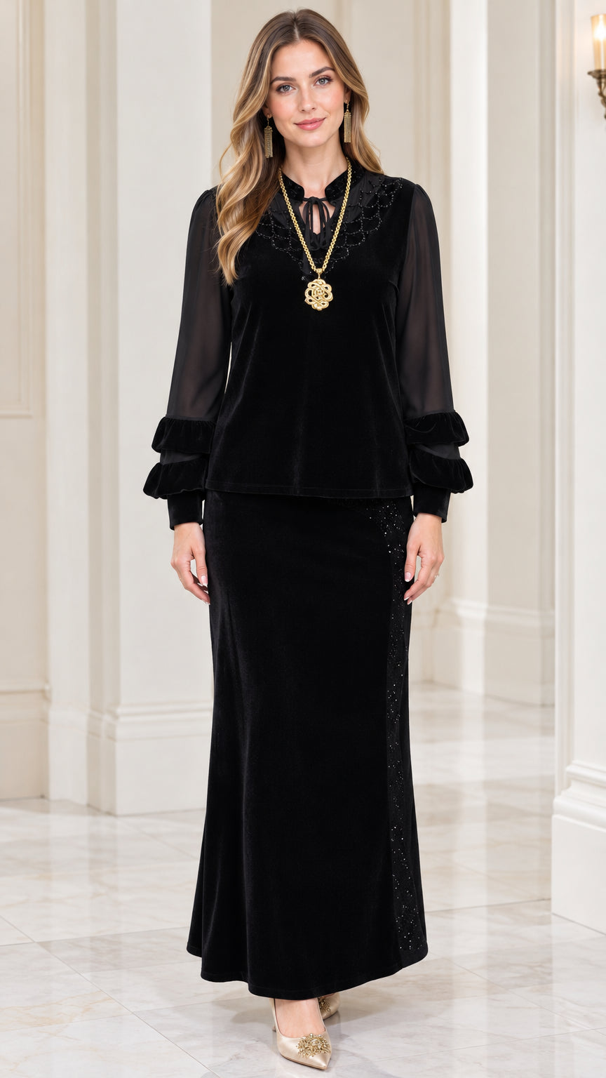 Front view of model wearing black embellished velvet top and maxi skirt set