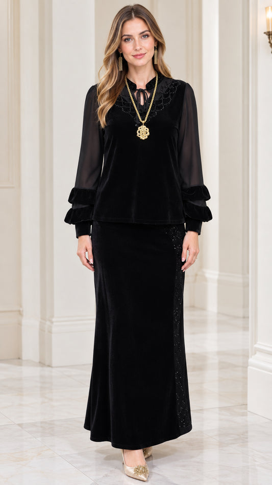 Front view of model wearing black embellished velvet top and maxi skirt set