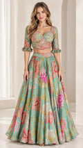 Front full view of woman wearing sage green floral print crop blouse and flared maxi skirt set
