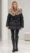 Front view of model wearing black belted puffer coat with plush faux fur collar