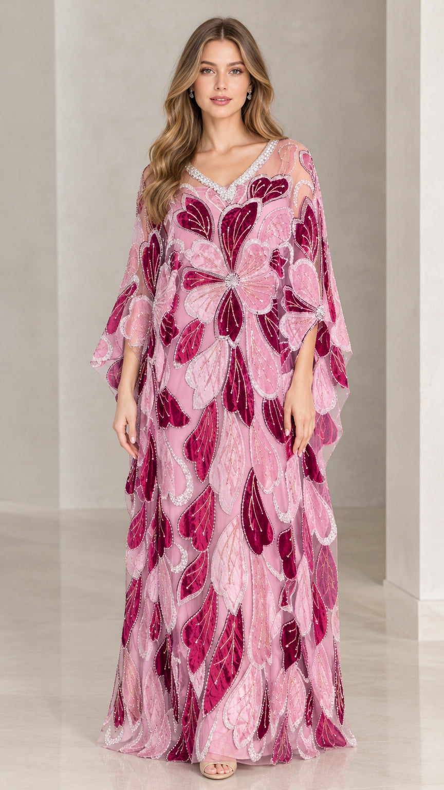 Front view of model wearing pink floral beaded kaftan maxi dress with crystal V-neckline