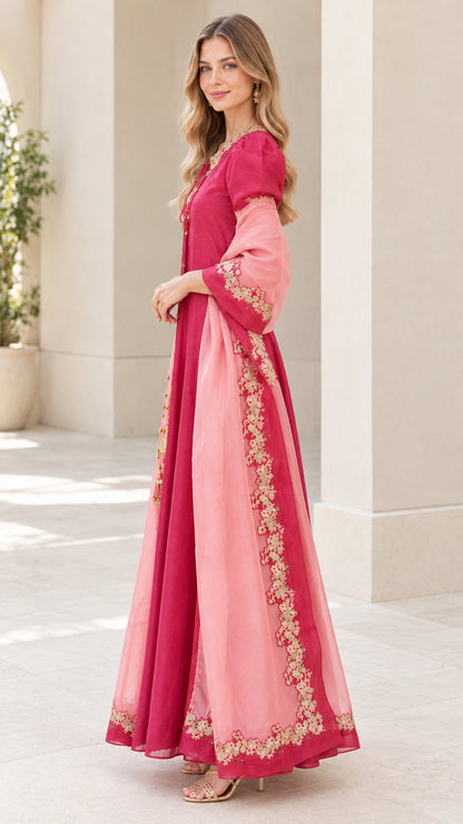 Side profile view of fuchsia pink embroidered evening maxi dress
