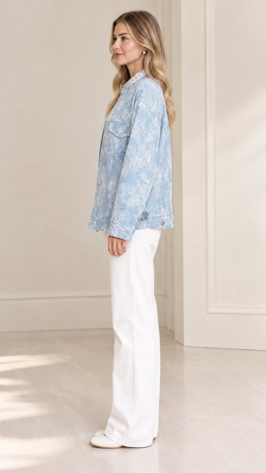 Side profile of model wearing light blue textured embroidered jacket
