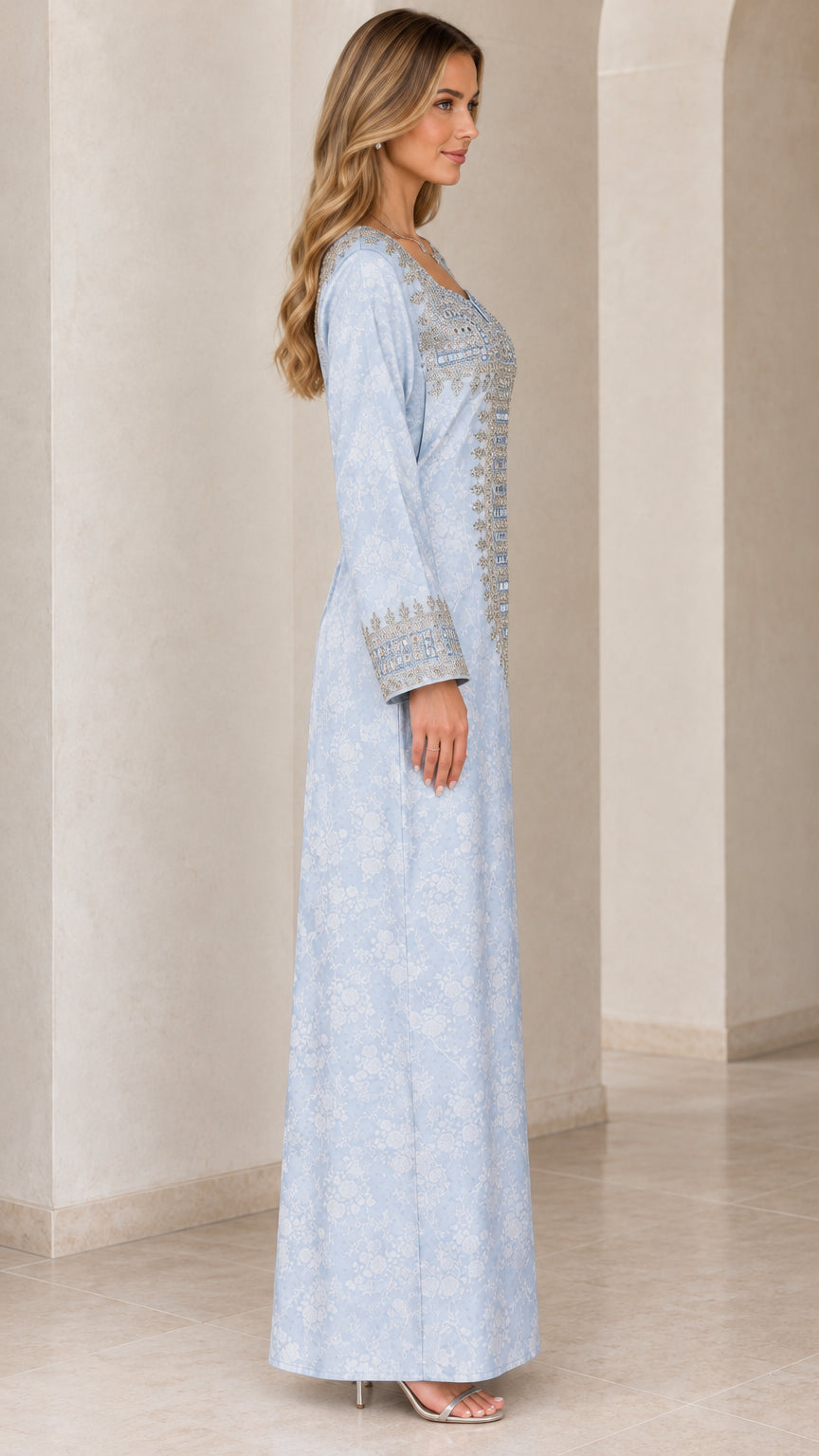 Side view of woman wearing light blue long sleeve embellished maxi dress