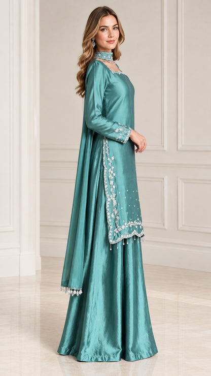 Side profile view of teal satin kurti and wide-leg sharara pants set