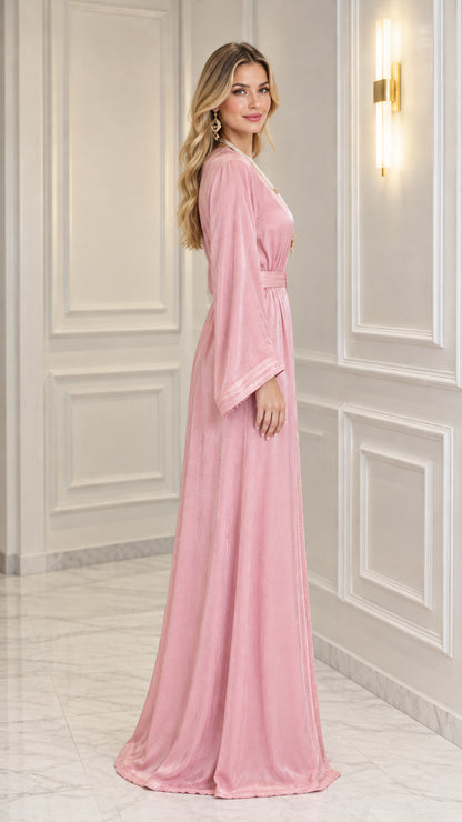Side angle view of woman wearing Rose Pink belted kaftan gown