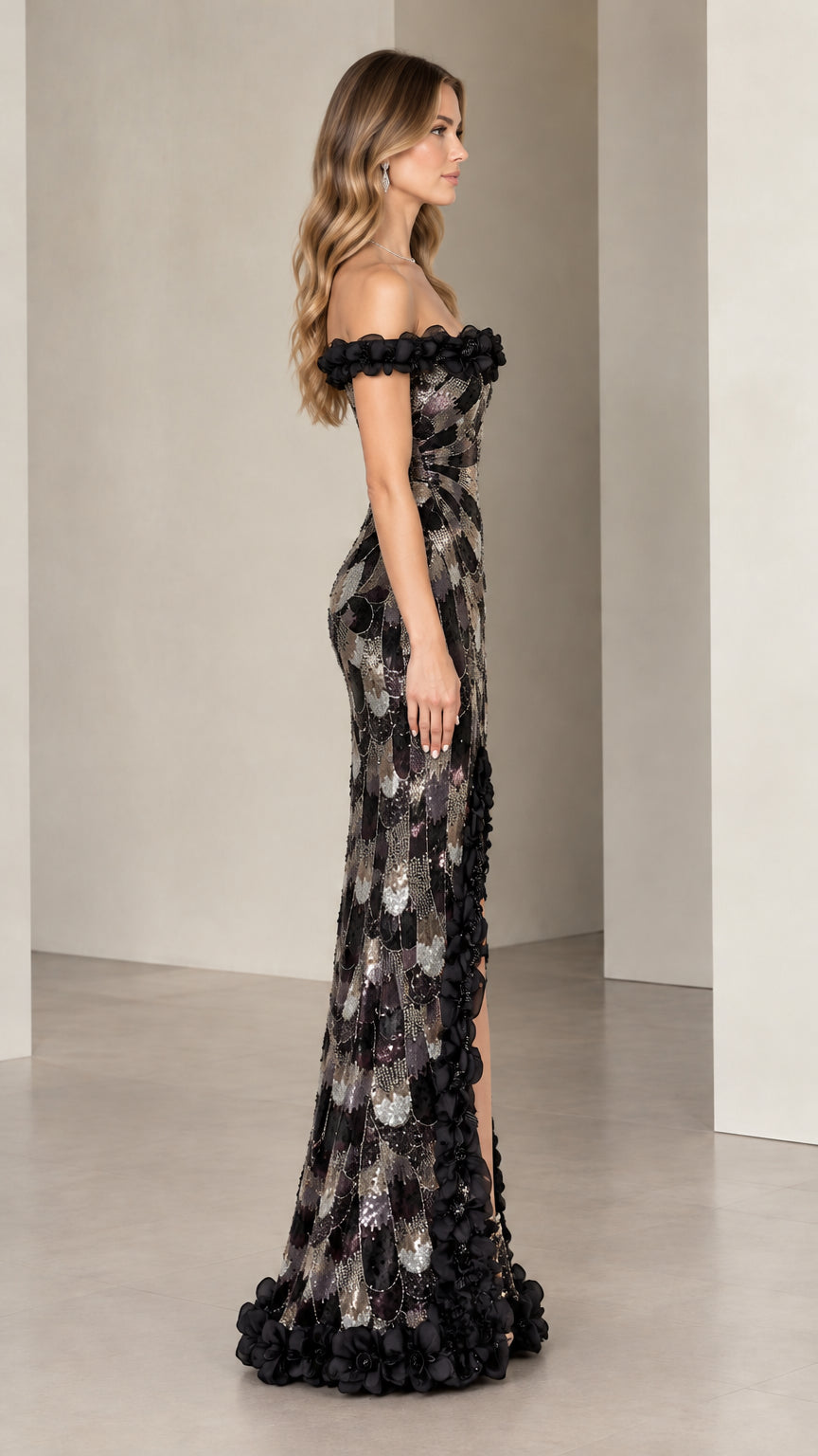 Side profile view of fitted black sequin maxi gown with floral applique details