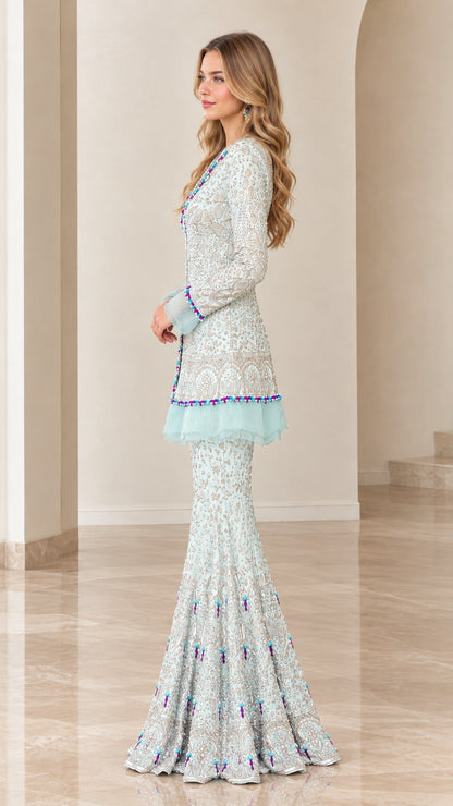 Side profile view of model wearing Ice Blue embroidered tunic and flared pants