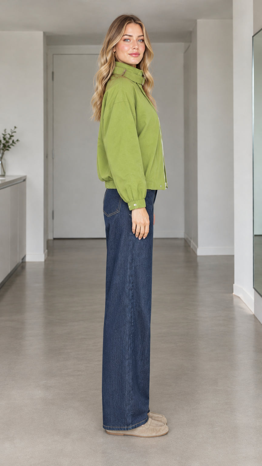 Side angle view of model wearing green utility zip-up jacket