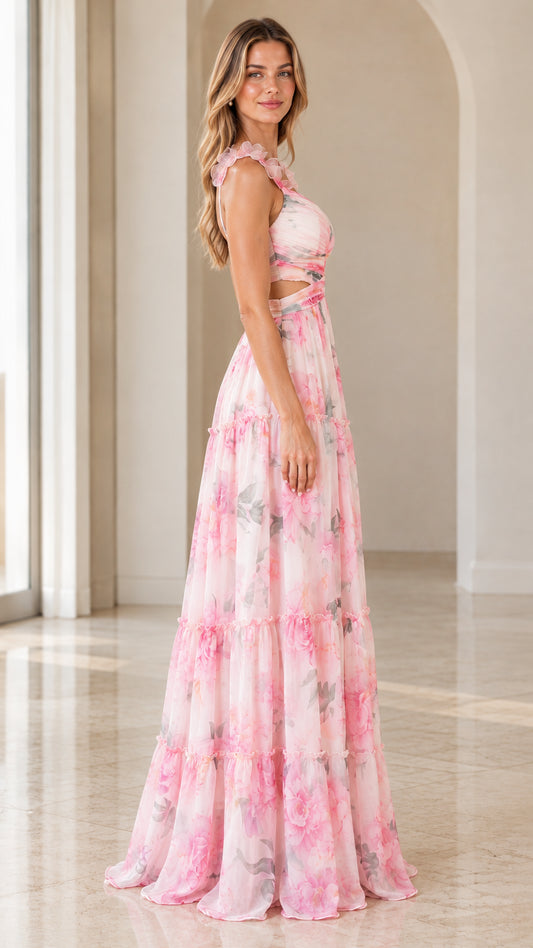 Side view of woman posing in pink floral sleeveless tiered maxi gown
