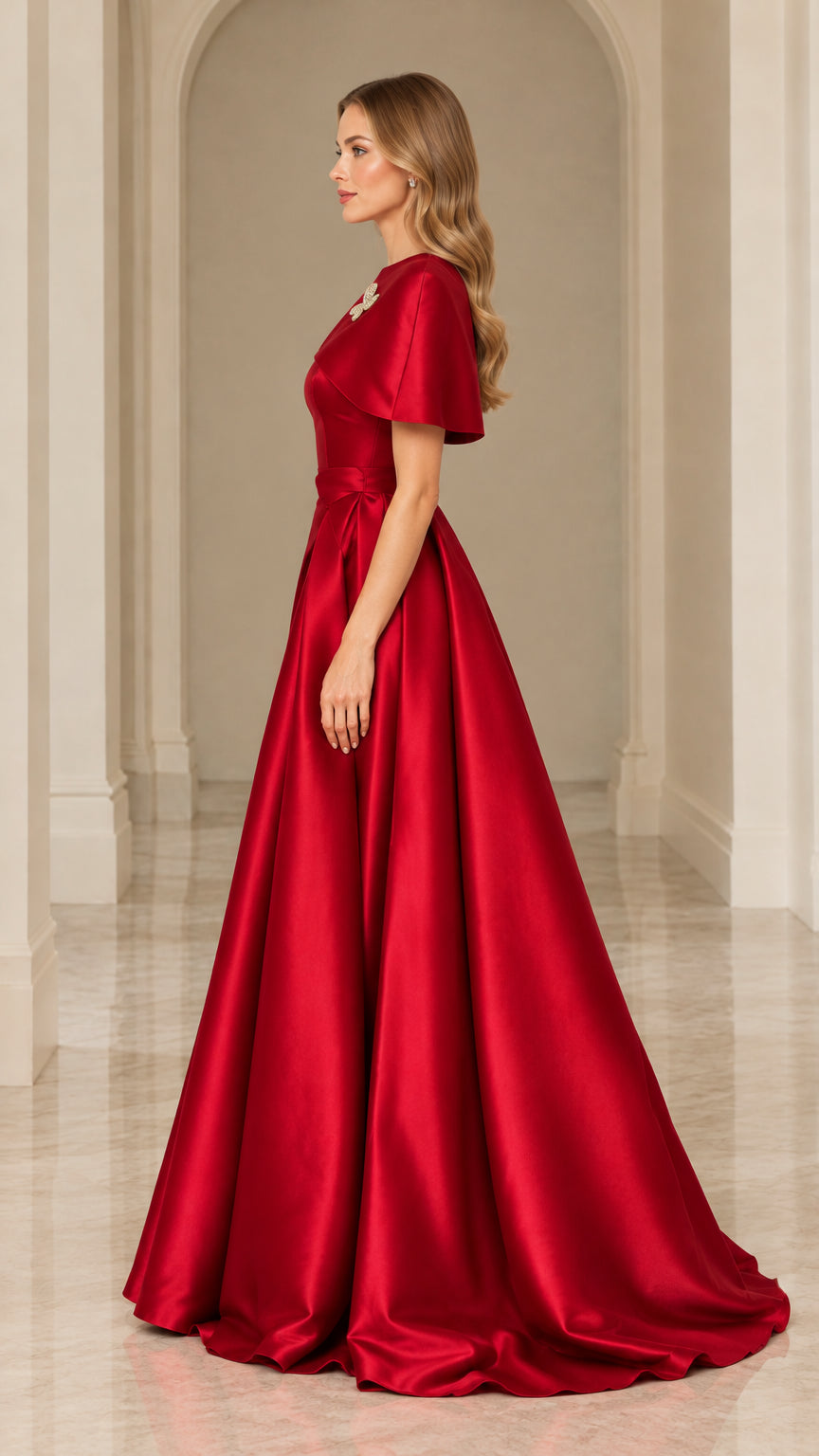 Side profile view of red satin floor-length formal gown with cape sleeve overlay