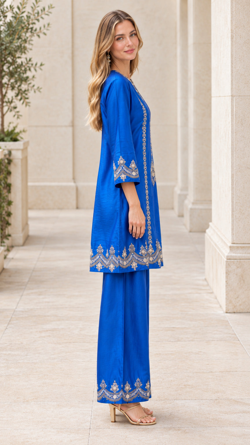 Side profile view of royal blue embroidered long tunic and trouser set