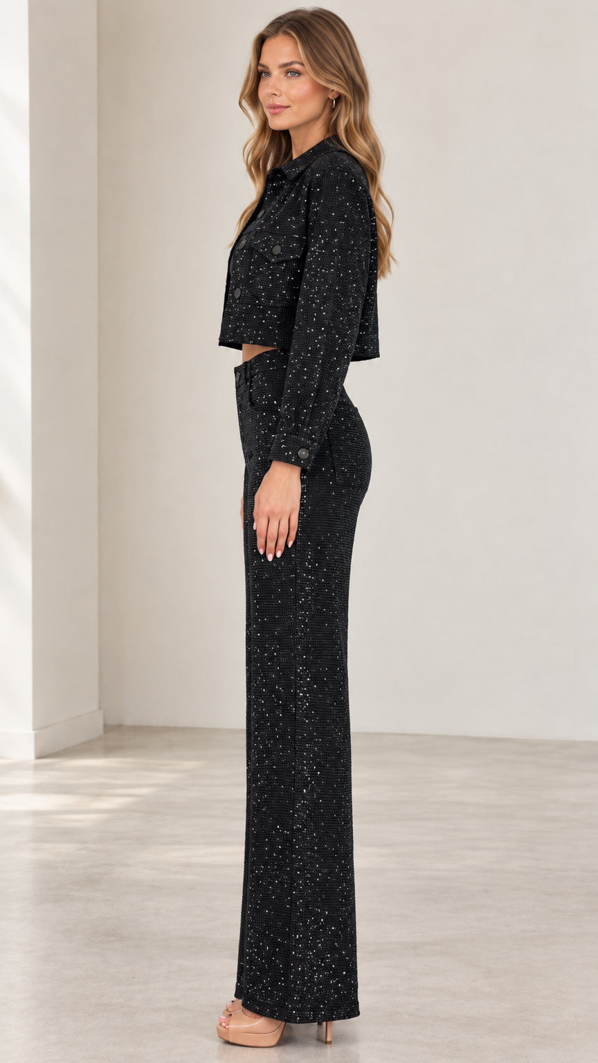 Side full-length view of black shimmering two-piece jacket and pants set