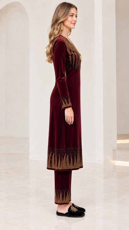 Side profile of women's burgundy velvet long tunic and trouser two-piece set