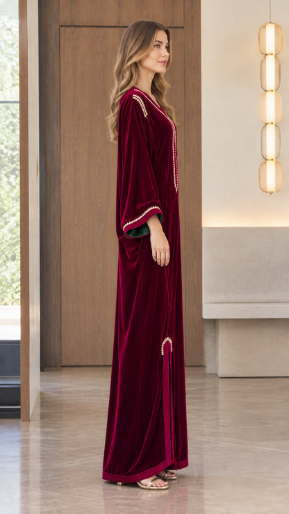Side profile view of model wearing the Burgundy embroidered velvet maxi dress