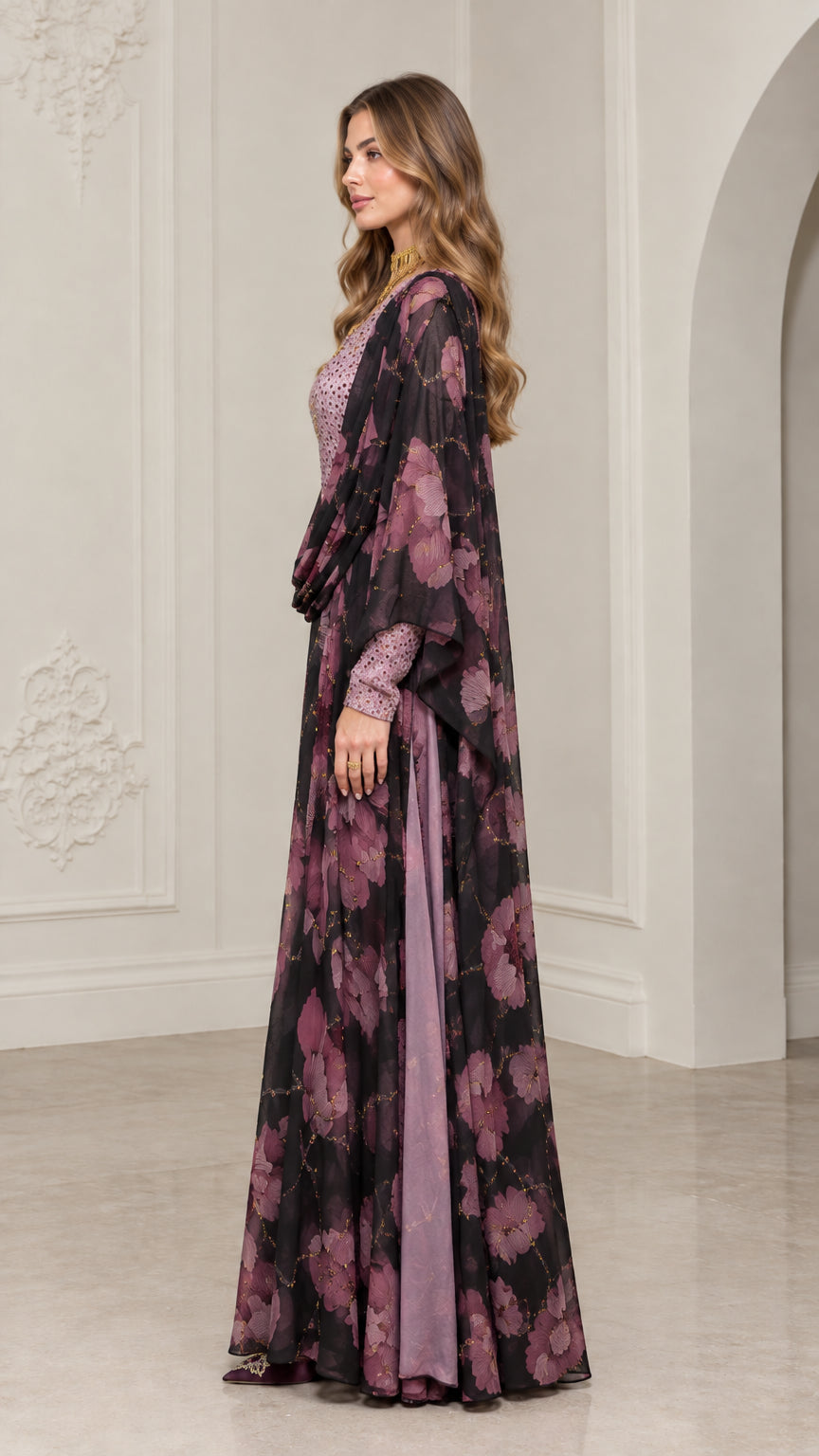 Side view of model in black floral kaftan dress with draped overlay