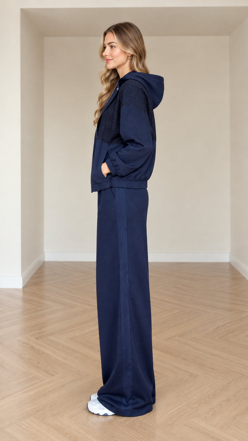 Side view of model wearing navy blue two-piece wide-leg tracksuit set