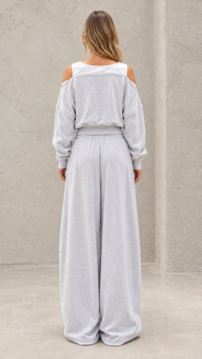 Back full-length view of model wearing heather grey cut out cropped lounge set
