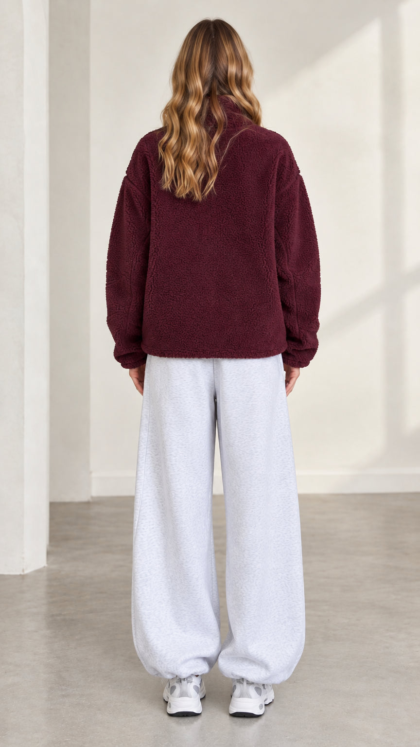 Back view of model in burgundy cozy fleece outerwear