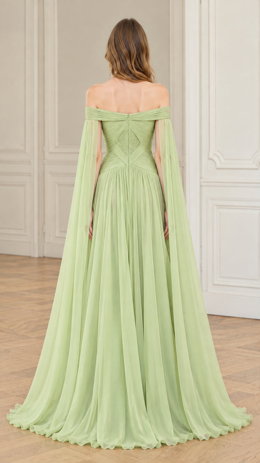 Back view of sage green formal evening gown showing pleated bodice and cape drape
