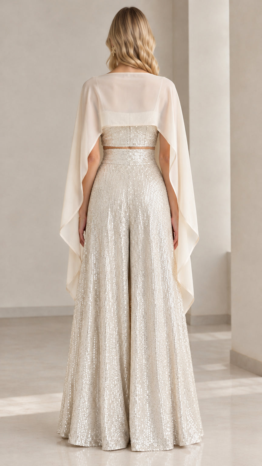 Back view of champagne sequin wide leg pants and sheer capelet ensemble