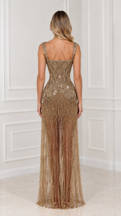 Back view of model in gold beaded maxi dress with cascading fringe