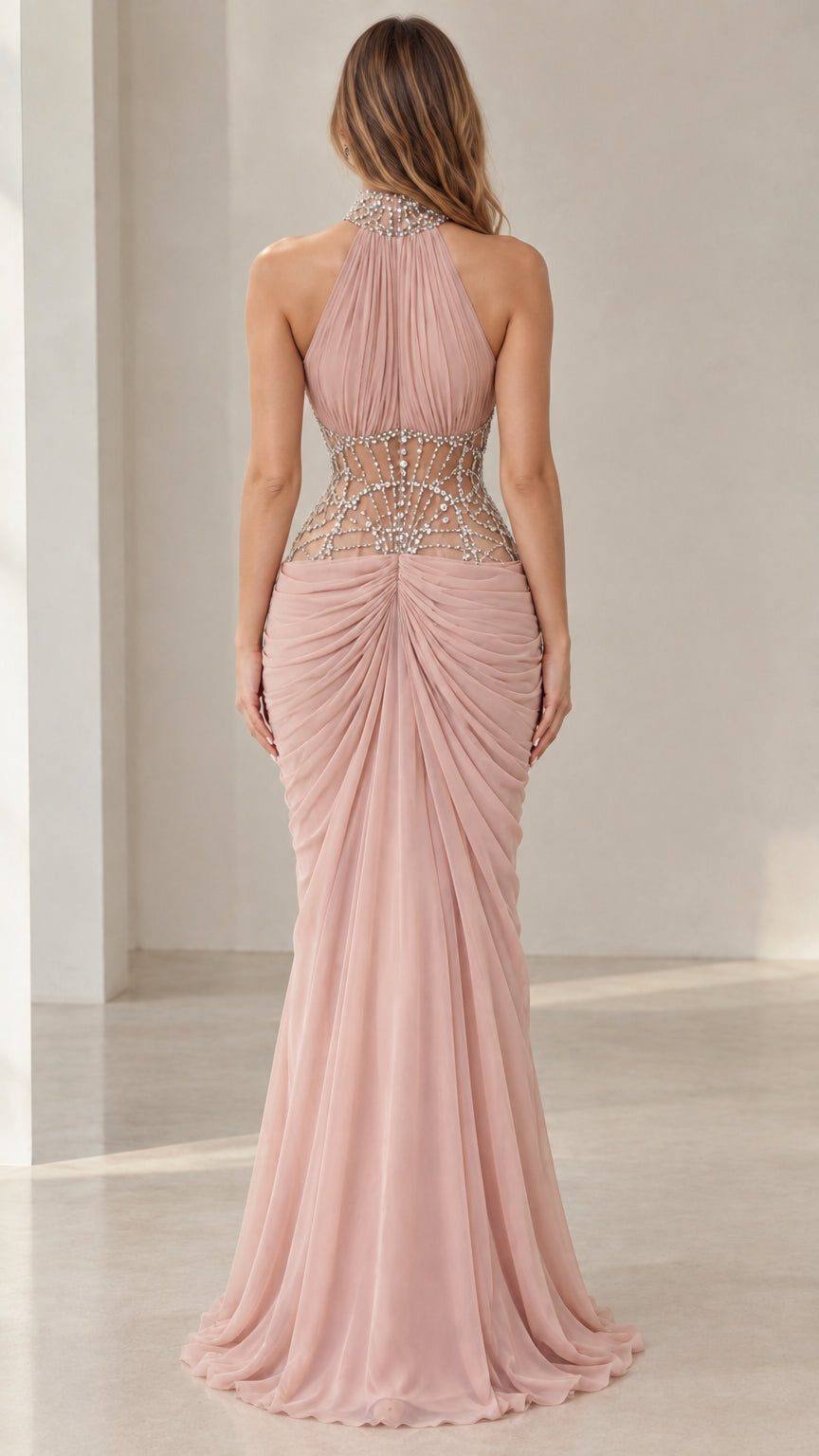 Back view of dusty pink halter neck formal gown showing embellished sheer waist