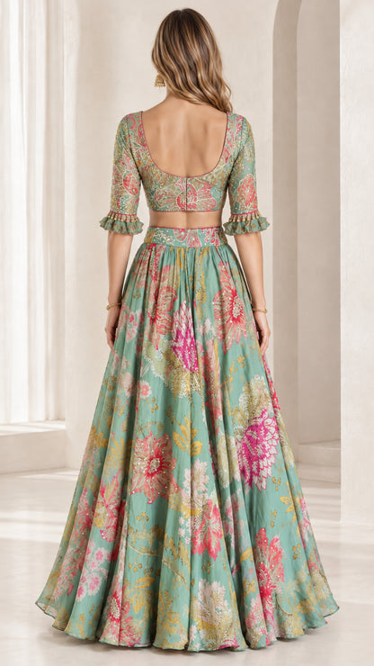 Back view of sage green floral crop top with low scoop back and flowing maxi skirt